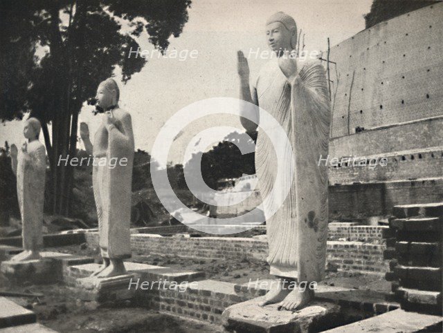 'Steinstatuen vor der in Wiederherstellung befindlichen Ruwanwali-Dagoba, Anuradhapura', 1926. Artist: Unknown.