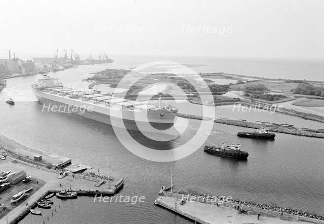Tugboats assist the M/S 'Varenna' to leave Landskrona shipyard, Sweden, c1970. Artist: Unknown