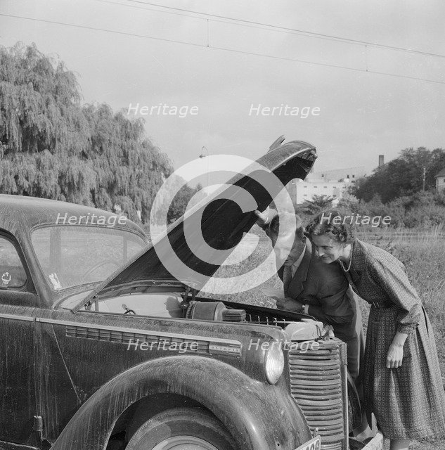 Checking the engine under the bonnet of an Opel Olympia, Landskrona, Sweden, 1959. Artist: Unknown