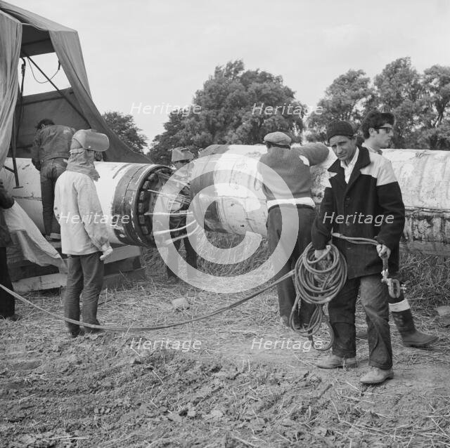 A team of men working on the lining up operation of the Fens gas pipeline, Norfolk, 24/07/1967. Creator: John Laing plc.