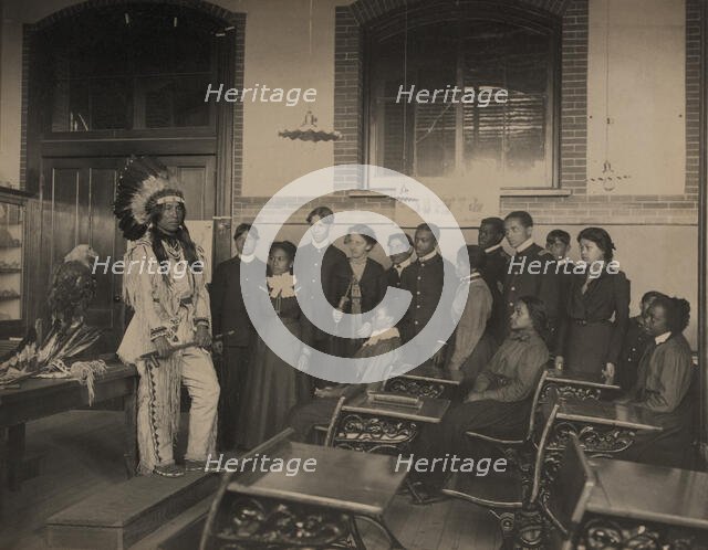 Louis Firetail (Sioux, Crow Creek), wearing tribal clothing, in American history..., 1899 or 1900. Creator: Frances Benjamin Johnston.