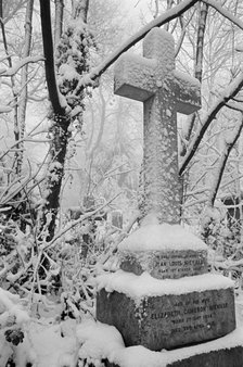 Cross on a grave in Highgate Cemetery, Hampstead, London, c1980-c1984. Artist: John Gay.