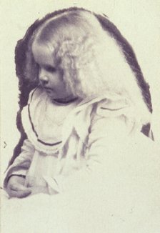 Young fair haired girl seated with hands in her lap, c1900. Creator: Estelle Huntington Huggins.
