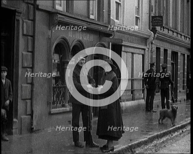 People Walking Along a Desolate Street in Ireland, 1921. Creator: British Pathe Ltd.
