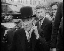 John D. Rockefeller Standing with Other People Next to a Car, 1933. Creator: British Pathe Ltd.