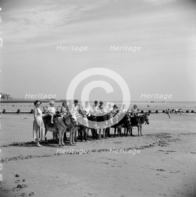 Donkey rides on the beach, Bridlington, East Riding of Yorkshire, 1950s. Artist: Hallam Ashley