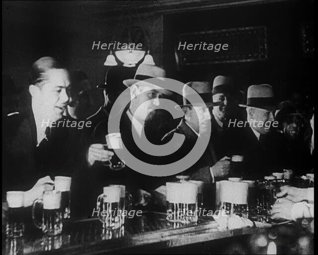 American Civilians Celebrating the End of Prohibition Drinking in a Bar, 1930s. Creator: British Pathe Ltd.