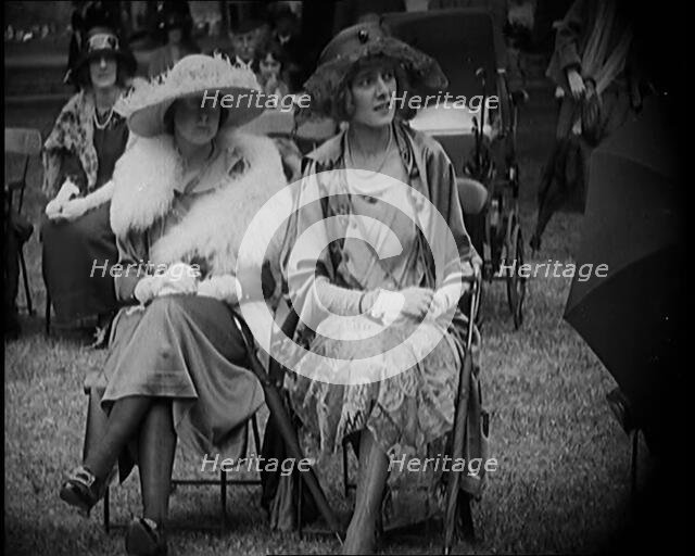Three Female Civilians Seating Outdoors Wearing Evening Outfits and Hats, 1920. Creator: British Pathe Ltd.