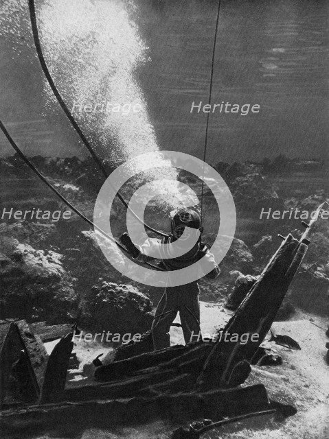 The first photograph of a diver under water, late 19th century, (c1920). Artist: Unknown