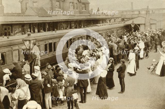 Crowds waving off troops leaving to fight in the First World, War, Britain, 1914, (1935). Creator: Unknown.