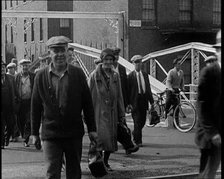 Workers Leaving Factory Through Factory Gates Which Are Closed After Them, 1932. Creator: British Pathe Ltd.