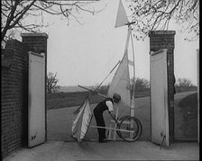 Male Civilian Carrying a Small Pedal Powered Flying Machine and Trying to Demonstrate It in a..., 19 Creator: British Pathe Ltd.