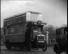 London Bus, Cars and Taxis Turning a Corner on a London Street, 1924. Creator: British Pathe Ltd.