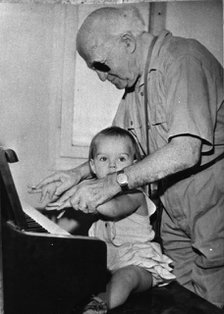 David Ben Gurion (1886-1973) trying to teach piano to his little granddaughter. Artist: Unknown
