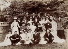 A group of hospital staff, including nurses wearing matching straw hats, standing outdoors. Creator: Unknown.