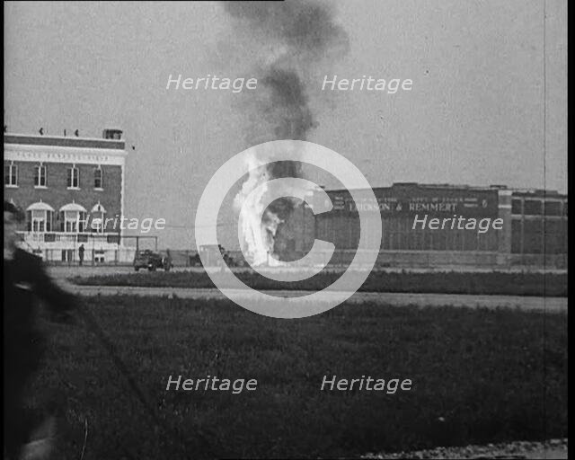 Plume of Flame Emitting from the ‘Bellanca’ Crash as People Attend to Wreckage, 1933. Creator: British Pathe Ltd.