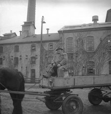 Man with a horse-drawn trailer at the sugar mill in Arlöv, Scania, Sweden, c1940s(?). Artist: Otto Ohm
