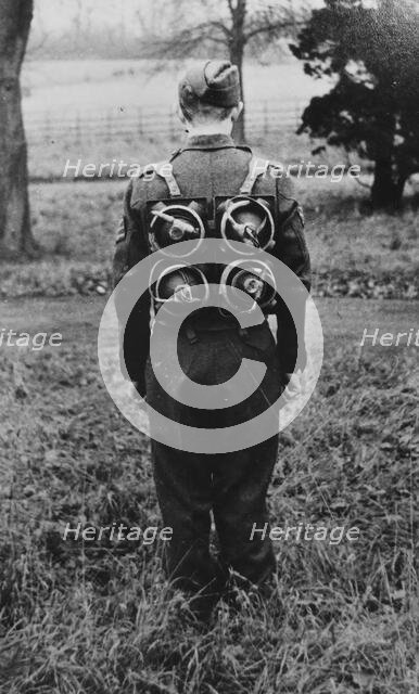 Limpet mines being carried on a harness on the back of a soldier, c1943. Creator: British Government.