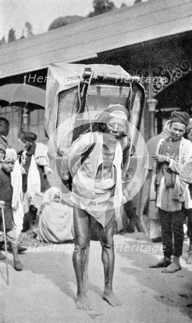 A labourer carrying tea, Darjeeling, West Bengal, India, c1910. Artist: Unknown