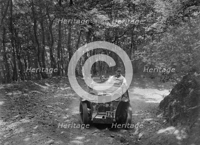 MG Magna competing in the B&HMC Brighton-Beer Trial, Fingle Bridge Hill, Devon, 1934. Artist: Bill Brunell.