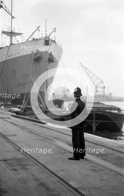 Port of London Authority policeman on patrol, c1945-c1965. Artist: SW Rawlings