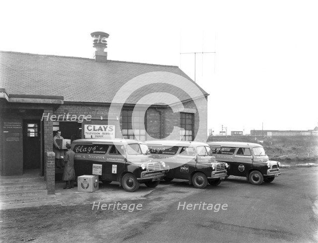 Austin vans being loaded outside Clays TV repair depot, Mexborough, South Yorkshire, 1959. Artist: Michael Walters
