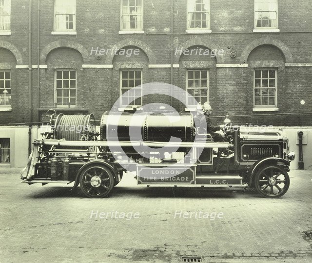Firemen aboard a foam tender, London Fire Brigade Headquarters, London, 1929. Artist: Unknown.