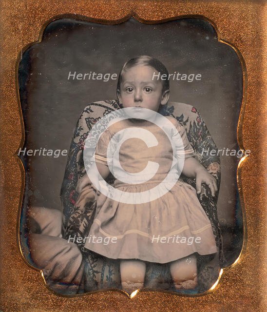 Child Sitting on Chair Draped with Floral Print Fabric, 1850s. Creator: Unknown.