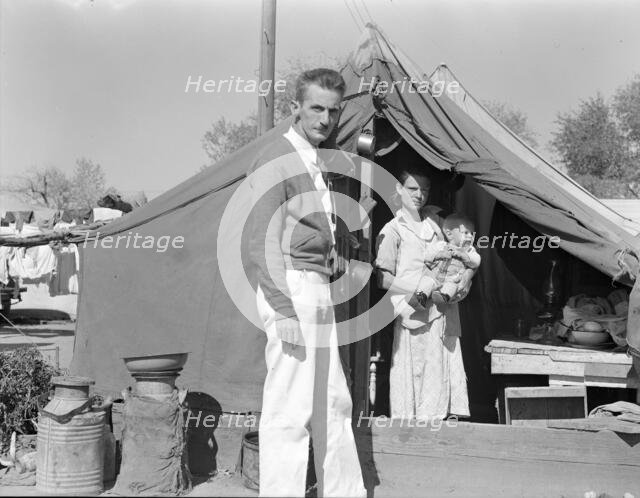 Tom Collins, manager of Kern migrant camp, California, with migrant mother and child, 1936. Creator: Dorothea Lange.