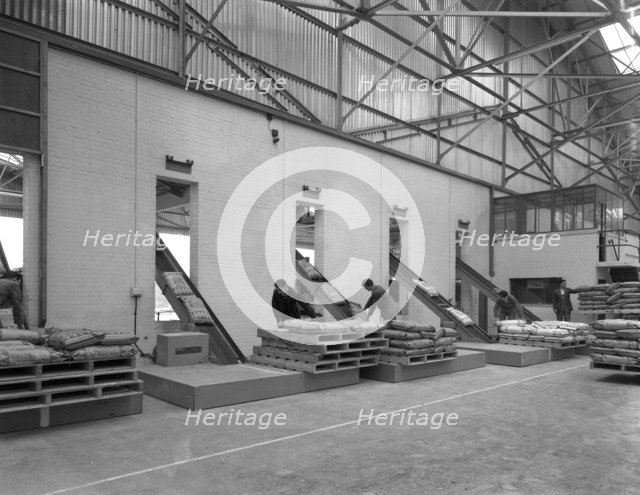 Loading animal feed onto conveyors, Spillers Animal Feeds, Gainsborough, Linconshire, 1961. Artist: Michael Walters