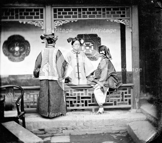 China: three Manchu ladies inside a courtyard, Beijing, 1869. Creator: John Thomson.