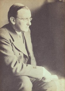 Portrait of man wearing glasses, seated with elbow resting on right knee , c1900. Creator: Eva Watson-Schutze.