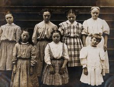 New York State Institute: a group of girls with Down's syndrome, standing on some steps, 1902. Creator: Unknown.