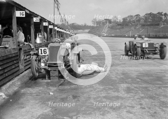 Mechanic working on a Lea Francis J type at the JCC Double Twelve race, Brooklands, May 1931. Artist: Bill Brunell.