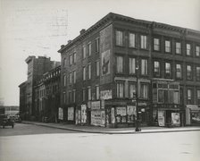 Boarded residential building on the corner of Madison Avenue and East 133rd Street..., 1938. Creator: Aubrey Pollard.