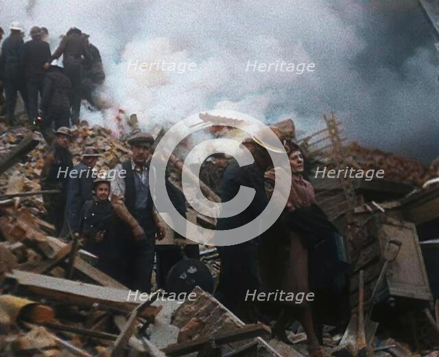 Firefighters Helping an Injured Civilian During the Blitz, 1940. Creator: British Pathe Ltd.