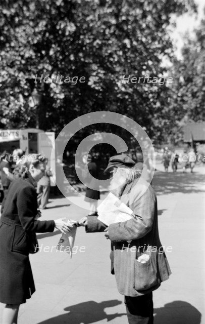 Newspaper seller, London, c1945-c1965. Artist: SW Rawlings
