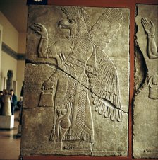 Assyrian relief of Winged genie carrying a cedar-cone. Artist: Unknown