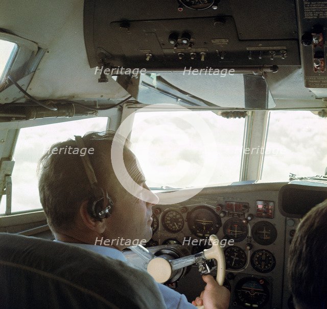 Piloting an Illyusin 18 Airliner. Artist: Unknown