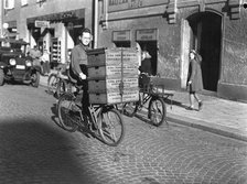 Delivery boy with bread boxes from the Lisa Öhman Bakery, Stockholm, Sweden, 10th October 1942. Artist: Karl Sandels