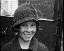A Young Female American Civilian Being Rescued from Kidnapping Smiling at the Camera, 1930. Creator: British Pathe Ltd.