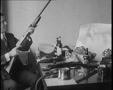 Male Detective Showing off Smugglers' Captured Guns, 1929.  Creator: British Pathe Ltd.