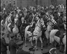 British Army Band on Horseback Parading Down a Street, 1937. Creator: British Pathe Ltd.