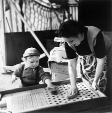 Woman and child at Hampstead fun fair, London, (early 1950s?). Artist: Henry Grant