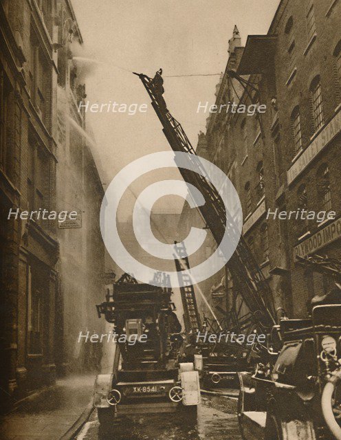 'How The London Fire Brigade Comes To Grips With Its Enemy', c1935. Creator: Unknown.