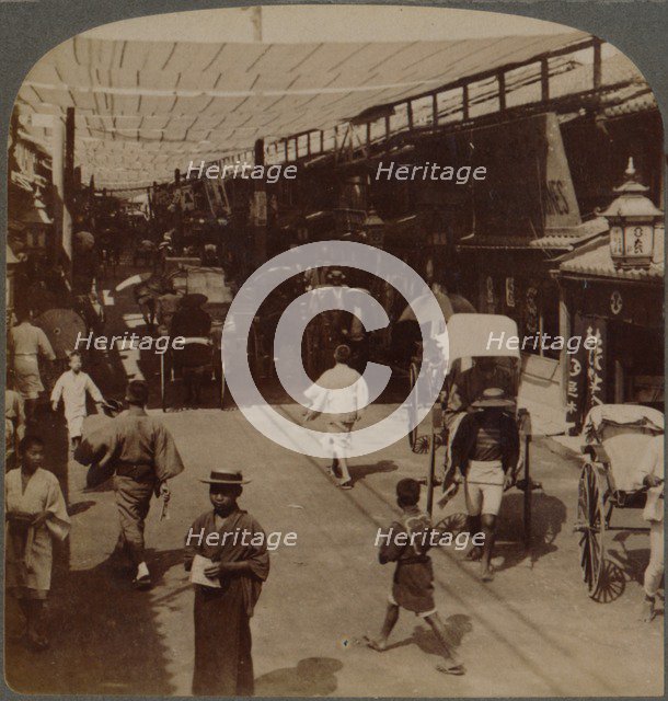 'Mid-summer traffic under awnings of Shiro-bashidori, a busy thoroughfare of Kyoto, Japan', 1904.  Artist: Unknown.