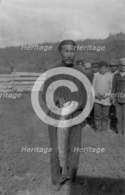 Shoria Man with Fish, Caught in the River Mrassu Rapid, 1913. Creator: GI Ivanov.