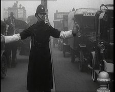 Male British Police Officer Controlling the Traffic On the Streets of London, 1920s. Creator: British Pathe Ltd.