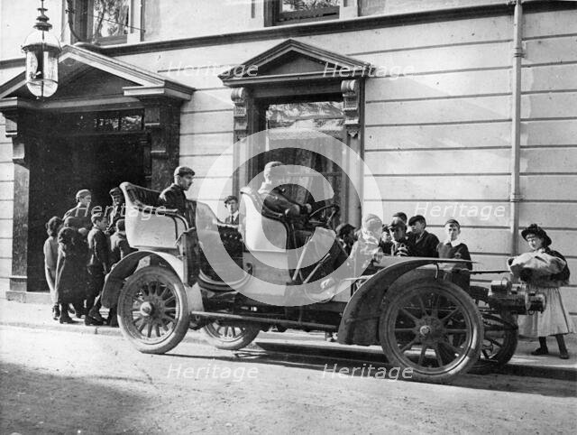 Claude Johnson behind the wheel of a 1905 Rolls-Royce 20hp. Creator: Unknown.