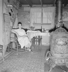 Mrs. Hull and corner of her one-room basement dugout, Dead Ox Flat, Malheur County, Oregon, 1939. Creator: Dorothea Lange.